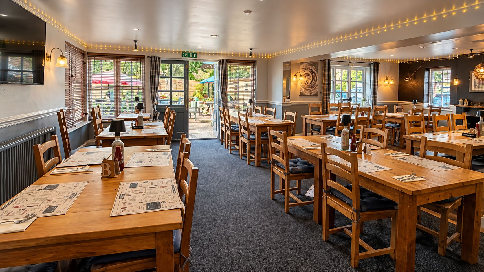 The dining room at The Barley Mow looking towards the open doors to the garden