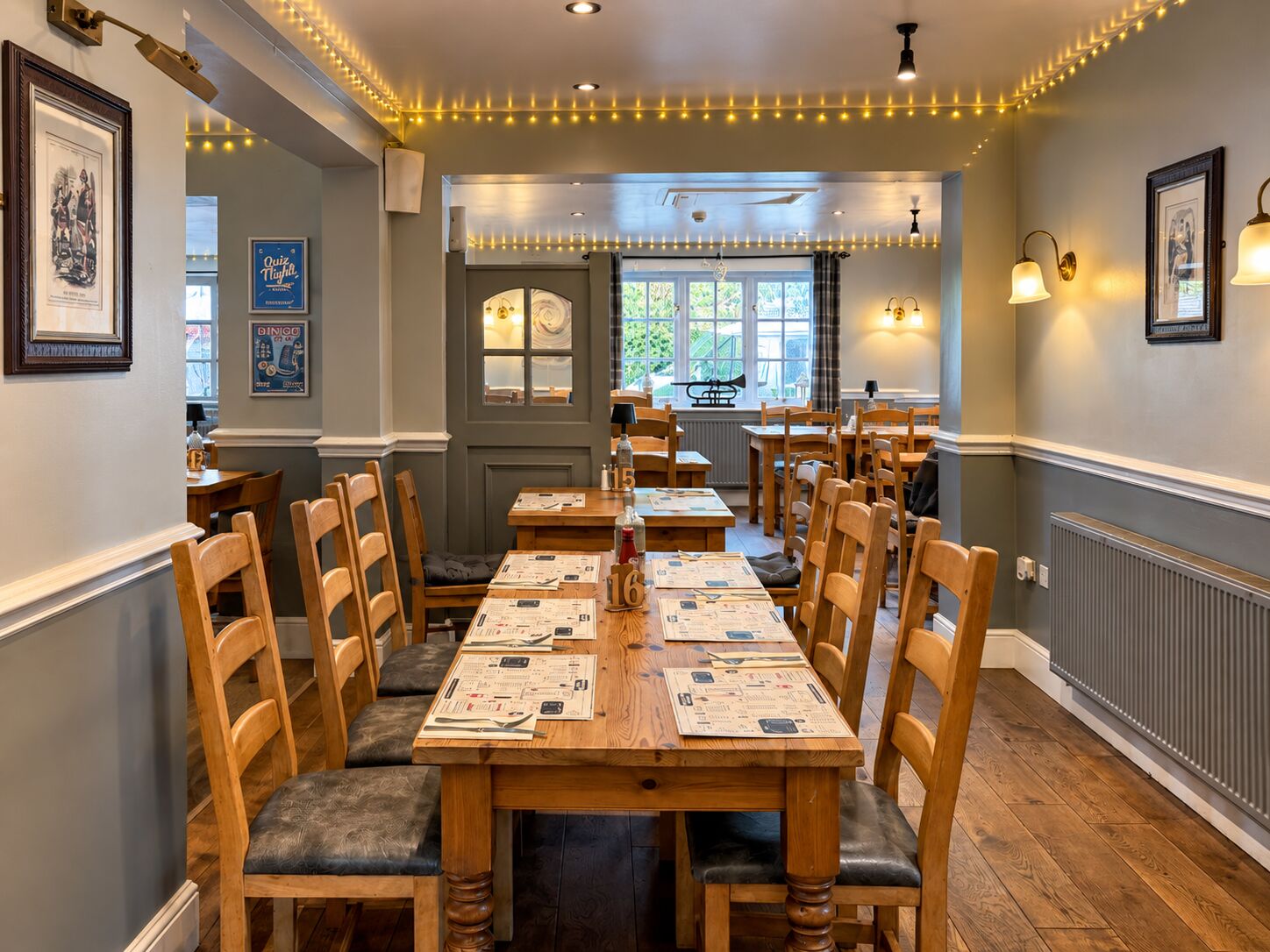 A long wooden dining table laid with menus and cutlery at The Barley Mow